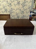 Closed wooden box, showing the exterior and latch