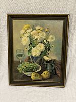 Full front view of the oil still life painting on canvas in a wooden frame, showing flowers, fruit, pitcher and glass.
