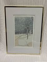 Full view of the framed winter scene artwork depicting snow-covered trees and a pathway with a street lamp.