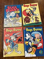 Four Bugs Bunny comic books with colorful 1950s covers featuring classic cartoon scenes and characters.