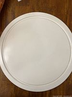 Top view of white Lazy Susan showing smooth round surface.