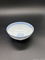 Photo of interior white eggshell porcelain cup with blue decorative border at rim and interior base