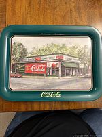 Front side of Coca Cola metal serving tray depicting Fleeman's Pharmacy building in Atlanta, Georgia with Coca Cola signage and branding.