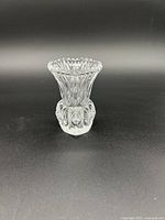 Front view of clear crystal bud vase showing flared top and intricate cut designs.