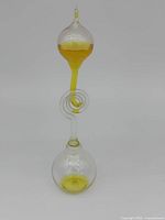 Front view of the yellow hand boiler glass sculpture on a plain background.