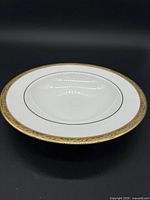 Top view of Lenox Landmark Gold soup bowl showing white porcelain with gold embossed rim and thin black line detail.