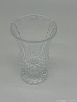 Front view showing the clear crystal vase with flared top and diamond cut pattern on the lower half.