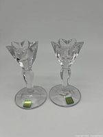 Pair of clear crystal candlestick holders with floral design and original Marquis by Waterford labels.
