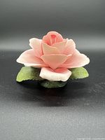 Porcelain pink and green Capodimonte rose figurine, side angle showing petal layers and leaves