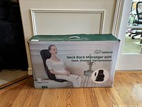 Front view of the boxed Snailax Neck Back Massager featuring product image of a seated woman using the massager.