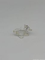 Front side view of clear Swarovski crystal cat figurine with black eyes and nose