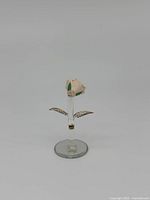Front view of the miniature pink ceramic rose on clear glass stem and base with gold leaf detailed leaves.