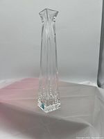 Photo of a clear glass flower vase by Tiffany & Co., tall and rectangular with fluted sides, shown on a white surface with a plain background.