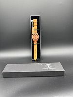 Full view of watch in black Viable Harvest branded box with lid beside it