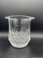 Front view of the clear crystal champagne bucket showing the cut glass diamond and vertical faceted pattern with two small handles.