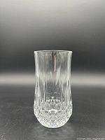 Single vintage crystal glass showing clear vertical fluting and diamond cut pattern at the base.