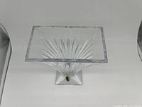 Top view showing square opening and starburst cut pattern inside the clear crystal vase.
