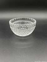 Clear Waterford Crystal Colleen condiment bowl showing cut panels and cross-hatch design under bright lighting.