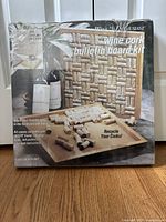 Photo of the Wine Enthusiast wine cork bulletin board kit sealed in original packaging with product image and details visible.
