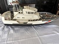 Side profile of the boat on table showing full hull and deck