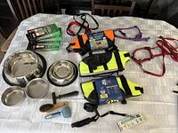 Top view of entire lot on table showing bowls, life preservers, leashes, collars, brushes, and bags.