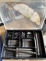 Plastic case with assorted drill bits including spade bit and hex shank bits