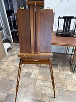 Front view of folding wooden French pochade box easel in standing configuration