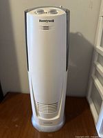 Front view of white and gray Honeywell humidifier showing brand and vent at base.