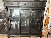 Front view of entire hutch showing three drawers and sliding glass doors