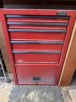 Closed red metal Job Mate tool chest with multiple drawers