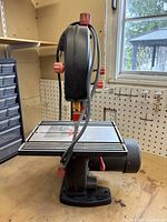 Left side close-up of the Jobmate bandsaw showing metal table, blade, adjustment knobs, and base.