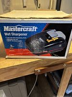 Photo of the original Mastercraft wet sharpener box showing the product image and key features.