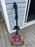 Front view of the Toro power shovel showing the handle and red housing with label