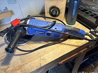 Side view of blue and black Simoniz right angle polisher/sander showing handle and cord wrapped around.