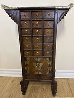 Full front view of apothecary chest on stand