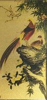 Close-up of the gold foil artwork showing two pheasants on a rock with bamboo and blossoms