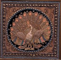 Front view of framed vintage Burmese tapestry showing beaded peacock design on black background with ornate frame.