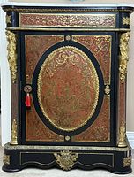 Full front view of ebonized wood cabinet with marble top, marquetry panels and ormolu mounts