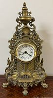 Front full view of ornate brass mantel clock
