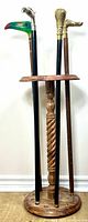 Front view of wooden cane stand holding four walking sticks