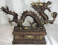 Front profile view showing dragon’s head turned to the right and rectangular base detailing