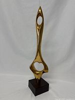 Full front view of the bronze statuette on wooden base