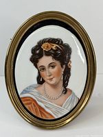 Front view of the oval framed hand painted porcelain lady portrait.
