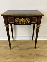 Front view of the Louis XVI style side table showing parquetry top and ormolu detailed drawer front.
