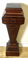 Full front view of mahogany Adam style carved plant stand showing square top with decorative molding and carved apron.