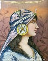 Close-up of the painted porcelain plaque showing the profile of the woman, headscarf details