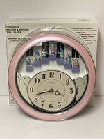 Front view of clock in box showing frame color and musicians