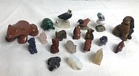 Group shot of 18 miniature gemstone animal figurines on white background