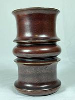 Full view of the brown Thomas Rosenthal ceramic vase with rounded ridges and flared lip.