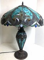 Full view of lamp showing stained glass shade and resin base